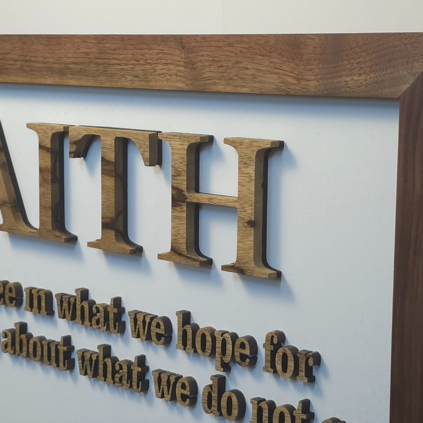 Decorative sign with 'FAITH' definition in a wooden frame on a light background
Handcrafted exotic wood Faith sign – 24x12 scripture wall art with laser-cut letters”
Rustic Christian home décor – wooden wall sign with natural wood frame